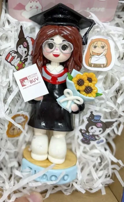 Handmade graduation clay figurine with flowers